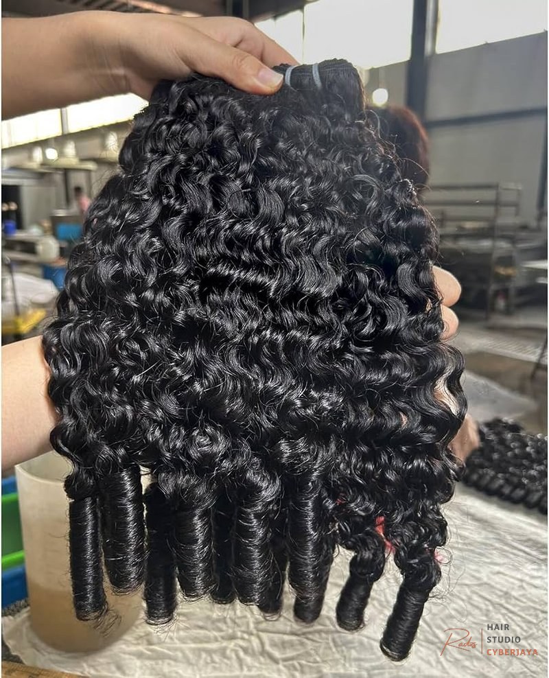 Unprocessed Burmese Curly Bundles A close-up of 100% unprocessed 16A raw virgin Burmese curly bundles, showcasing tight spiral curls in natural color, ideal for deep wave styles.