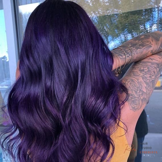 Woman with long dark purple hair created using Wella Professionals