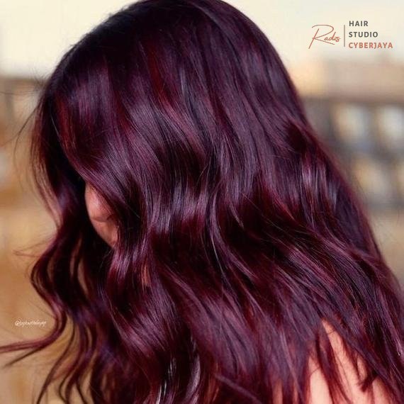 Rich plum hair color ideas Woman showcasing her rich plum hair color