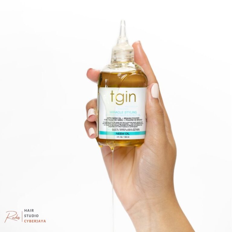tgin Miracle Styling Ayurvedic Hair & Scalp Oil held in hand